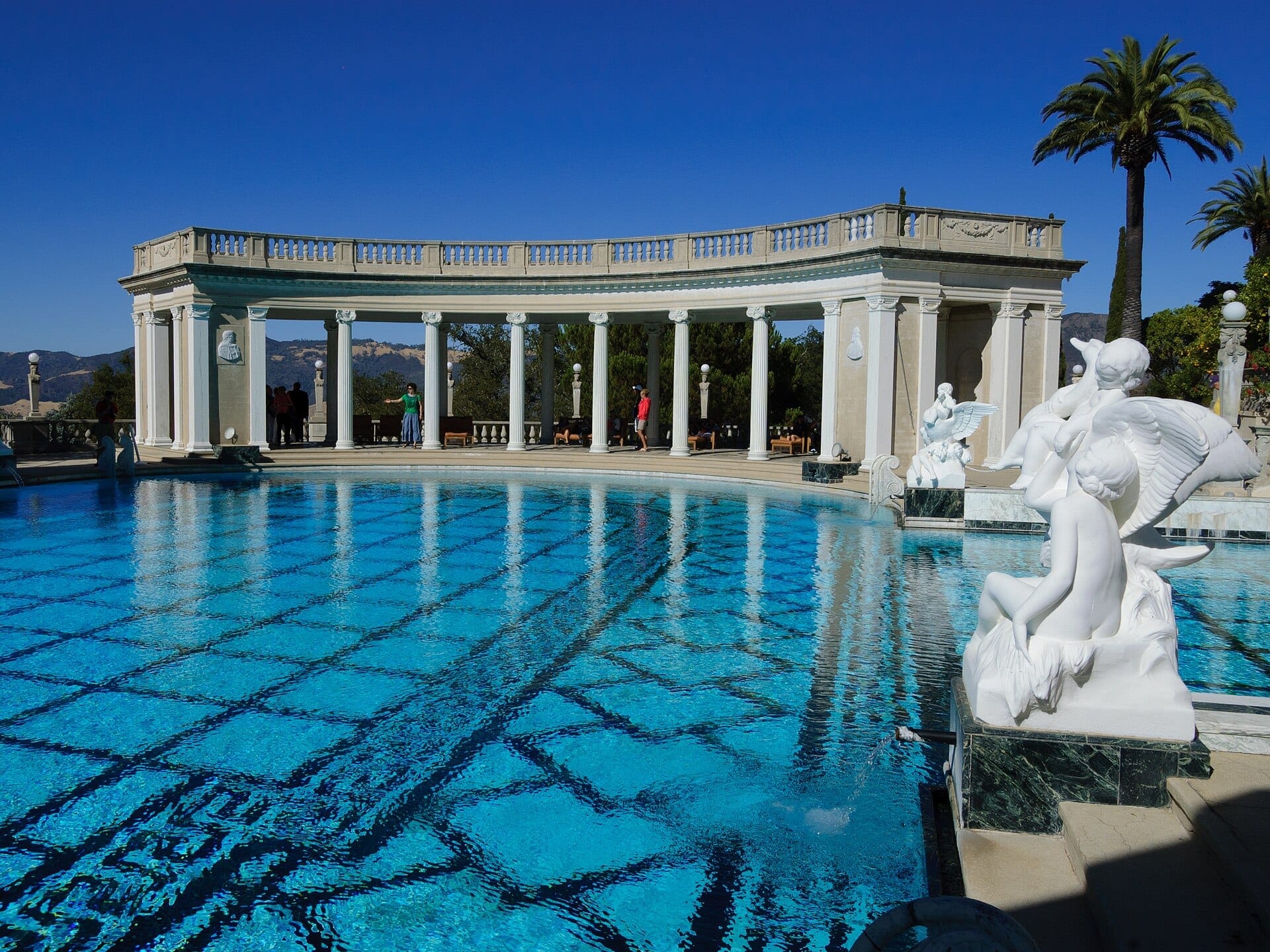 The Greco-Roman Neptune Pool at Hearst Castle, framed by colonnaded pavilions and an ancient temple facade