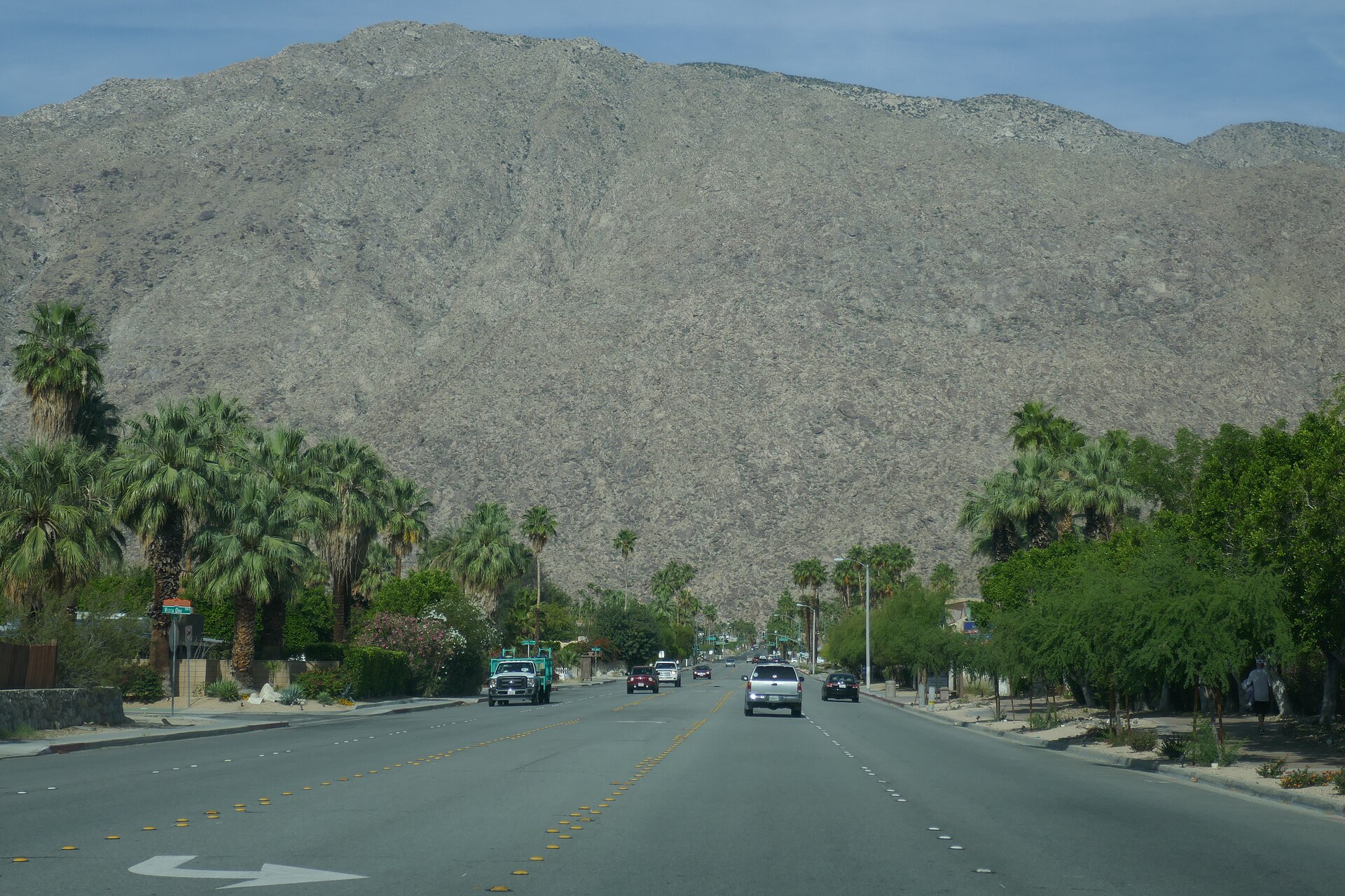 A palm-lined Palm Springs street beneath the San Jacinto Mountains